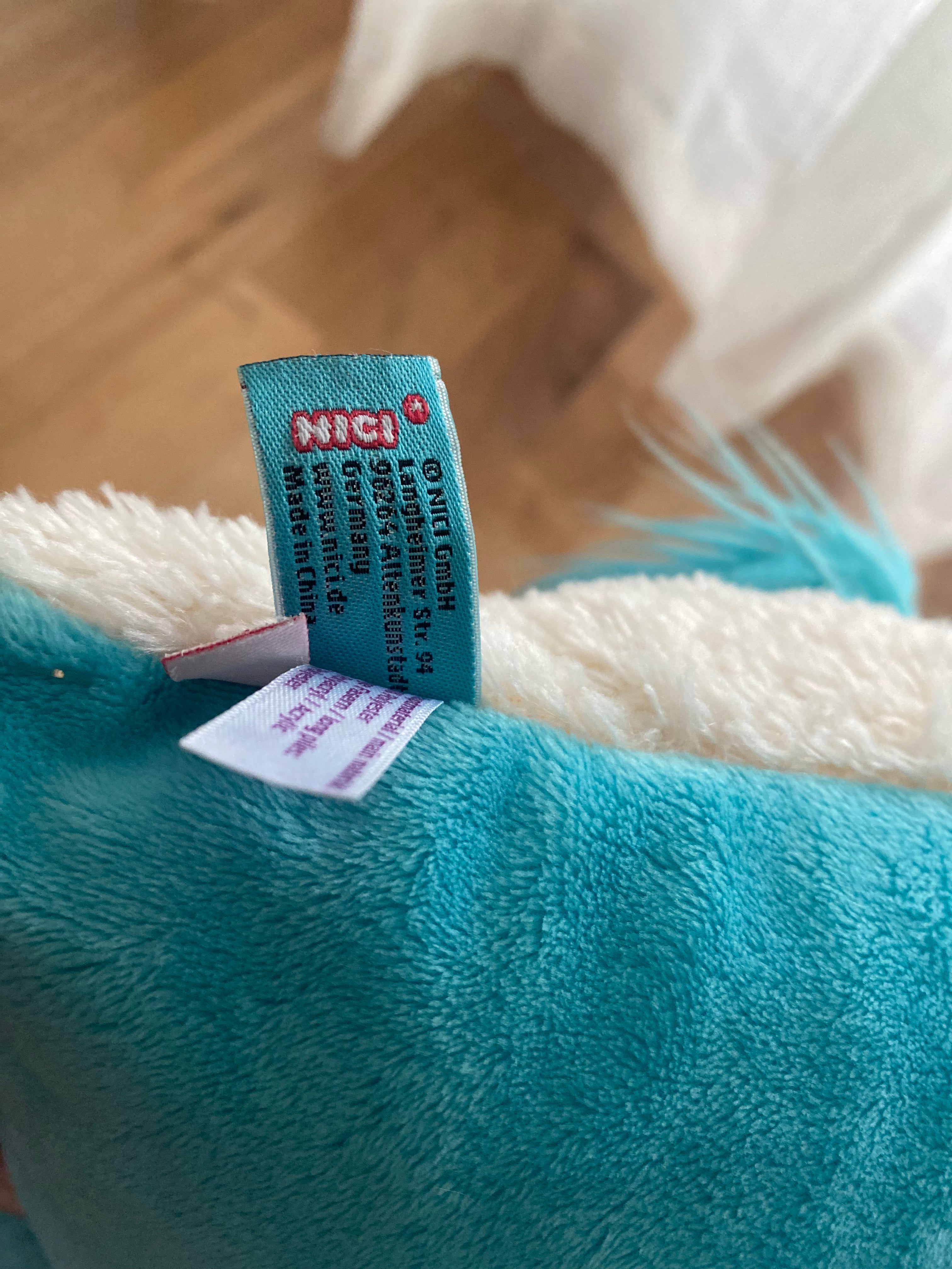 Original NICI Einhorn Kuschelkissen aus cremefarbenem Plüsch mit türkisfarbener Mähne
Logo